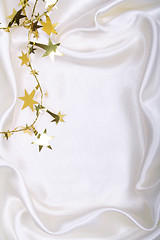 Image showing Golden stars and spangles on white silk