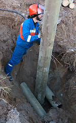 Image showing Installing a power pole in the pit