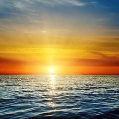Image showing orange sunset over dark blue sea