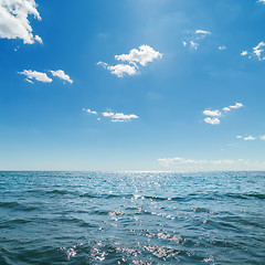 Image showing dark blue sea and deep blue sky with clouds