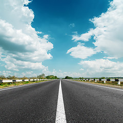 Image showing white line on asphalt road and clouds over it