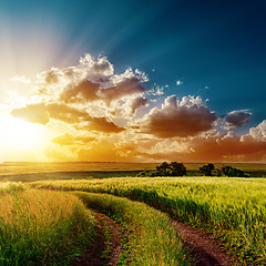 Image showing dramatic sunset over road in fields