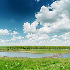 Image showing river in green grass and clouds in blue sky