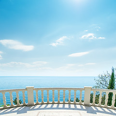 Image showing white balcony near sea and light clouds on sky