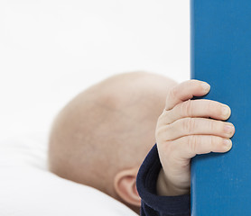 Image showing nurslings hand holding blue wooden board