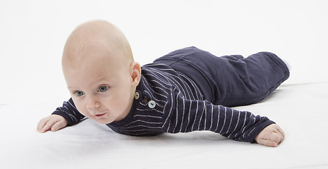 Image showing cheerful baby trying to get around