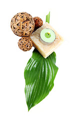 Image showing Green leaf, soap and candle