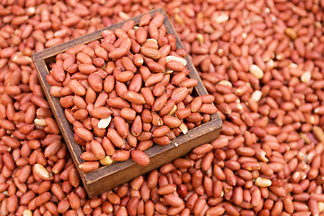Image showing Peanut kernels with wooden container