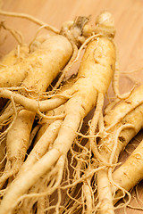 Image showing Ginseng with wooden background