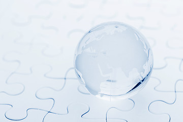 Image showing Glass globe ball on puzzle