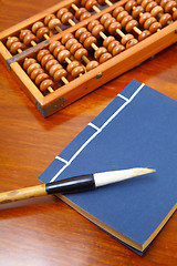 Image showing Chinese book , abacus and writing brush