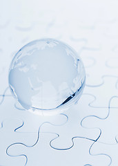 Image showing Crystal glass globe ball on puzzle