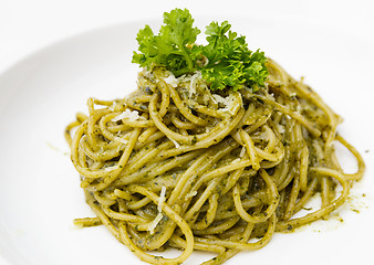 Image showing Italian pasta spaghetti with pesto sauce and basil leaf