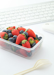 Image showing Berry mix lunch box on working desk