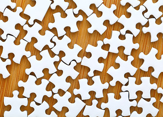 Image showing Puzzle pieces with wooden background