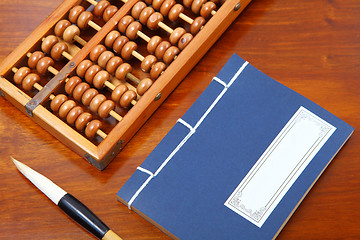 Image showing chinese book , abacus and writing brush