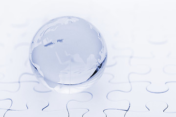 Image showing Crystal glass globe ball on puzzle