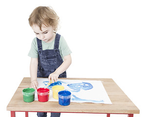 Image showing child making painting on small desk