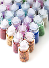 Image showing Small Glass Jars filled with Balls of Bead