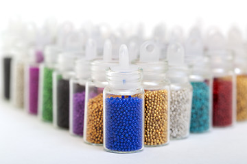 Image showing Small Glass Jars filled with Balls of Bead