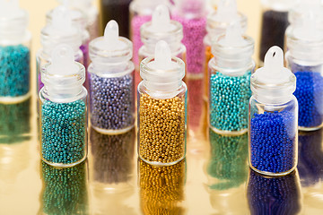 Image showing Small Glass Jars filled with Balls of Bead