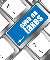 Image showing save on taxes word on laptop keyboard key, business concept