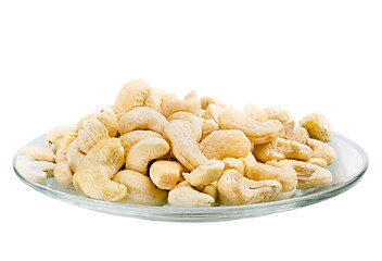 Image showing Saucer with a row cashew nuts isolated on white background
