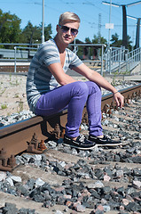 Image showing One man on train tracks