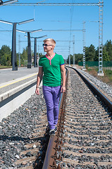 Image showing Handsome man on train tracks