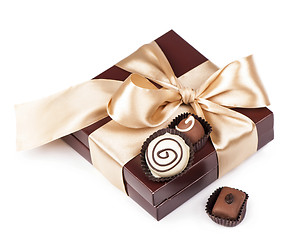 Image showing brown box with candies and golden tape