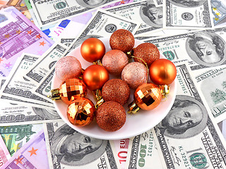 Image showing Christmas balls set on white plate, dollar background