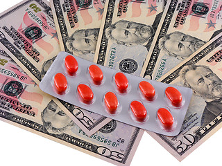 Image showing medical pills on dollars bank note as symbol for high costs