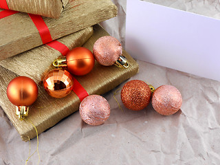 Image showing Golden gift box set with red ribbon, christmas balls and empty card