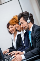 Image showing friendly callcenter agent operator with headset telephone 