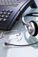 Image showing working place office desk table headset glasses telephone