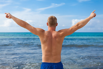 Image showing attractive young athletic man on the beach