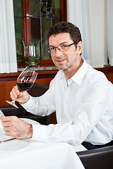 Image showing couple drinking red wine in restaurant