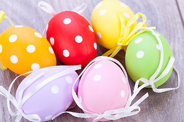 Image showing colorful easter egg decoration on wooden background