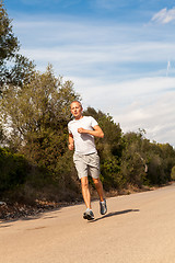 Image showing athletic man runner jogging in nature outdoor