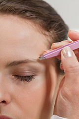 Image showing young beautiful woman eyebrow plucking tweezers eyes hair 