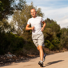 Image showing athletic man runner jogging in nature outdoor