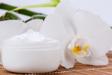 Image showing cosmetic face cream on wooden background 