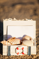 Image showing sailing boat and seashell in sand decoration closeup