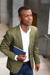 Image showing smiling successful businessman with tablet pc outdoor