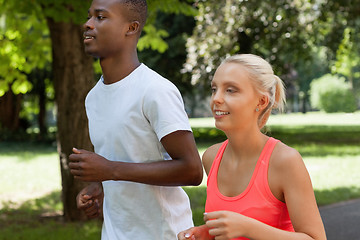 Image showing young couple runner jogger in park outdoor summer