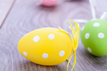 Image showing colorful easter egg decoration on wooden background