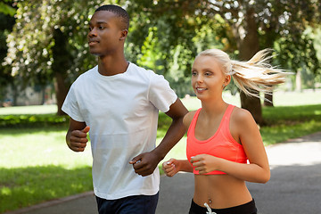 Image showing young couple runner jogger in park outdoor summer