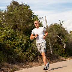 Image showing athletic man runner jogging in nature outdoor