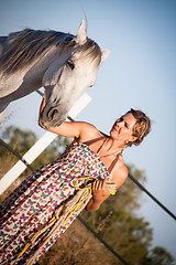 Image showing young woman walking a road with horse