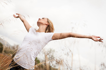 Image showing young happy attractive woman arms wide open 